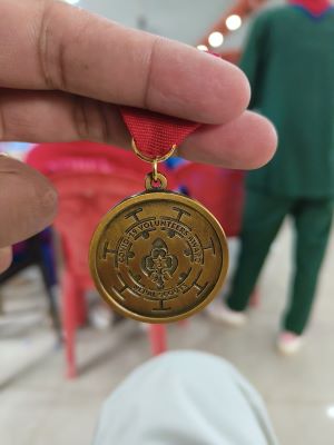Photo of a medal with the words COVID-19 VOLUNTEERS AWARD.
